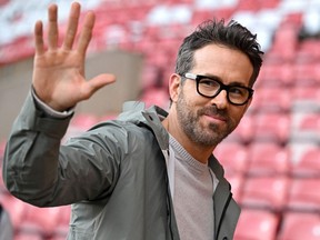 Actor and Wrexham owner Ryan Reynolds waves to fans ahead of the English FA Cup fourth round football match between Wrexham and Sheffield United at the Racecourse Ground Stadium in Wrexham, north Wales, on January 29, 2023.