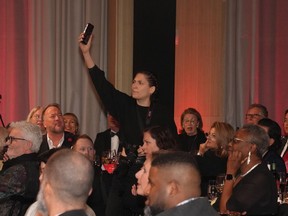 A protester films herself as she interrupts the Scotiabank Giller Prize in Toronto, on Monday, November 13, 2023. The ceremony was twice interrupted by anti-Israel protests.