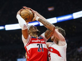 Washington Wizards centre Daniel Gafford (21) is fouled by Toronto Raptors centre Jakob Poeltl (19) at the net during first half NBA basketball action in Toronto on Monday, November 13, 2023.