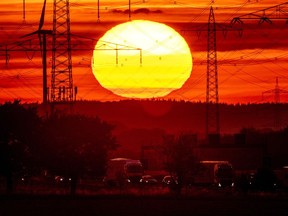 FILE - The sun rises above a highway in Frankfurt, Germany, Aug. 2, 2022. Former NASA top scientist James Hansen is warning that global warming is accelerating faster than most models are showing, a contention that other scientists think is overblown. He argues that since 2010 there is more sun energy in the atmosphere, and less of the particles that can reflect it back into space thanks to efforts to cut pollution.