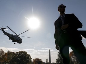 The Washington Monument is visible as a member of the Secret Service stands guard in front of Marine One with President Joe Biden abroad as it lifts off from the South Lawn of the White House in Washington, Thursday, Nov. 9, 2023, for a short trip to Andrews Air Force Base, Md., and then on to Illinois.