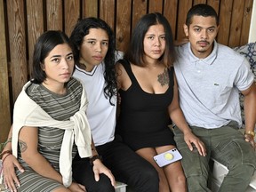 Erika Erazo, Erica Umana, Dayri Amaya and Brandon Cuevas pose for a photo on Sept. 5, 2021, in Landover Hills, Md. The four filed a federal lawsuit on Nov. 27, 2023, that accuses police officers of illegally entering their Maryland apartment without a warrant, detaining roommates and unnecessarily shooting their pet dog, which was left paralyzed and ultimately euthanized.