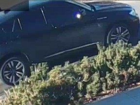 The Edmonton Police Service has released a photo of an SUV, as shown in this handout image, as well as surveillance video of two suspects in last week's fatal shootings of a gang member and his 11-year-old son while they were parked outside a fast-food restaurant.