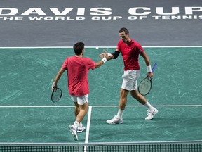Canada's Vasek Pospisil, right, and Canada's Alexis Galarneau react after winning a point against Finland's Harri Heliovaara and Finland's Patrik Niklas-Salminen during a Davis Cup quarterfinal tennis match between Canada and Finland in Malaga, Spain, Tuesday, Nov. 21, 2023.
