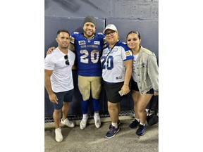 Winnipeg Blue Bombers' Brady Oliveira, centre left, poses for a family photo with, from left to right, brother Kyle Oliveira, mom Shani Oliveira and sister Kallee Oliveira in Winnipeg in an Aug. 24, 2023, handout photo at the Winnipeg Blue Bombers' 47-17 win over the Montreal Alouettes.