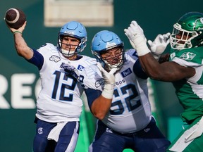 Toronto Argonauts quarterback Chad Kelly (12) throws against Saskatchewan Roughriders during the first half of CFL football action in Regina, Sask., on Saturday, October 21, 2023. Record-setting Kelly and rushing leader Brady Oliveira are the finalists for the CFL's outstanding player award.