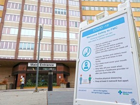 A COVID-19 information sign is seen outside the Foothills Medical Centre in Calgary on Tuesday, Oct. 13, 2020.