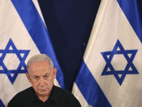Israeli Prime Minister Benjamin Netanyahu attends a press conference with Defense Minister Yoav Gallant and Cabinet Minister Benny Gantz in the Kirya military base in Tel Aviv, Israel, Oct. 28, 2023.