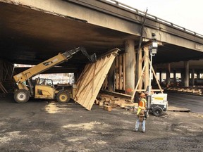 This photo provided by the California Department of Transportation shows a work crew shoring up a section under Interstate 10 that was severely damaged in a fire in an industrial zone near downtown Los Angeles on Wednesday, Nov. 15, 2023. The area under the freeway that burned last weekend, damaging a section of a key thoroughfare in the car-dependent city, was stacked with flammable materials on lots leased by the state through a little-known program that now is under scrutiny.