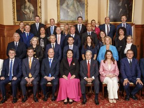 New Zealand Prime Minister Christopher Luxon, front row, fourth from left, sits with Gov. Gen. Dame Cindy Kirk, center, and ministers and undersecretaries for their official photograph following the swearing-in ceremony at Government House, in Wellington, New Zealand, Monday, Nov. 27, 2023. Luxon, a 53-year-old former businessman, was officially sworn in as New Zealand's 42nd prime minister on Monday, and said his top priority was to improve the economy.
