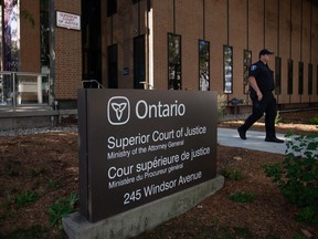 A police officer is seen outside downtown Windsor's Superior Court of Justice building on Sept. 5, 2023.