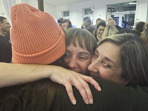 Democrat Susan Gibson, middle, hugs supporters after an announcement that she and fellow Democrats swept the Central Bucks, Pa., school board races on Wednesday, Nov. 8, 2023.
