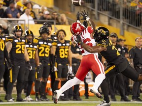 Injuries last season limited the 6-1, 231-pound Simoni Lawrence to just nine regular-season games with the Hamilton Tiger-Cats. Lawrence (21) successfully defends agains a catch attempt by Calgary Stampeders running back Dedrick Mills (26) during first half CFL football game action in Hamilton, Ont., Saturday, Sept. 30, 2023.