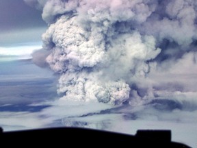 A cloud of volcanic ash and steam rises as Mount Ulawun erupts, seen from 30,000 feet in the air, on April 30, 2001. Authorities have downgraded the alert level for Papua New Guinea's tallest volcano, Tuesday, Nov. 21, 2023 and ruled out a tsunami a day after it erupted, spewing smoke as high as 15,000 meters (50,000 feet).