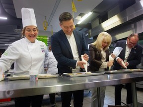 Conservative Party of Canada Leader Pierre Poilievre helps decorate Smile Cookies at the UHC Hub of Opportunities in Windsor with community kitchen GECDSB teacher Adelina DeBlasis (left), UHC CEO June Muir and local MP Chris Lewis (C — Essex) on Wednesday, Nov. 15, 2023.