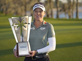 Brooke Henderson holds up the championship trophy after winning the LPGA Hilton Grand Vacations Tournament of Champions, Sunday, Jan. 22, 2023, in Orlando, Fla. Henderson loves breaking records and this week she's got a dubious one hanging over her head.