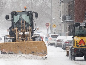 A plow clears a street during a snowstorm in Montreal, Tuesday, Feb. 28, 2023.