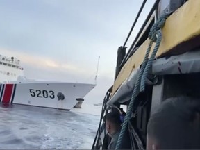 FILE - In this image from a video released by the Armed Forces of the Philippines, Filipino sailors look after a Chinese coast guard ship with bow number 5203 bumps their supply boat as they approach Second Thomas Shoal, locally called Ayungin Shoal, at the disputed South China Sea on Oct. 22, 2023. Chinese and Southeast Asian diplomats renewed a vow to finalize a nonaggression pact for the South China Sea in three years, two regional diplomats said Thursday, Nov. 2, 2023. (Armed Forces of the Philippines via AP)