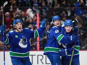 Vancouver Canucks' Andrei Kuzmenko, of Russia, from left to right, Elias Pettersson, of Sweden, and Bo Horvat celebrate Pettersson's tying goal against the Seattle Kraken during the third period of an NHL hockey game in Vancouver, on Thursday, December 22, 2022.&ampnbsp;Elias Pettersson has one hope for Vancouver Canucks fans as ex-captain Bo Horvat makes his return to Rogers Arena on Wednesday.THE CANADIAN PRESS/Darryl Dyck