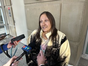 Deborah Poitras speaks to reporters after the court appearance of an Alberta man charged with murder in her cousin's 1976 death, in Calgary on Nov. 14, 2023.