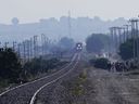 FILE - A northbound freight train moves along the tracks where migrants wait for an opportunity to hop on a passing train in Huehuetoca, Mexico, May 12, 2023. Mexico's president announced Nov. 8, 2023 that he will require private rail companies that mostly carry freight to offer passenger service or else have the government schedule its own trains on their tracks.