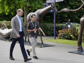 Britain's Prince William, left, walks with Felix Loh, CEO of The Gardens by the Bay, as the prince arrived to meet with Earthshot finalists at the city-state's famed park in Singapore, Tuesday, Nov. 7, 2023. William is in Singapore for the annual The Earthshot Prize awards ceremony, the first to be held in Asia. William and his charity launched the global competition in 2020 to promote innovative solutions and technologies to combat global warming and protect the planet.