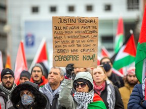 Protesters call for Prime Minister Justin Trudeau to pressure Israel to stop fighting, one day after Hamas broke the ceasefire agreement, on Parliament Hill in Ottawa, on Saturday.