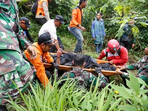 Rescuers carry away a victim after the eruption of Mount Marapi on Dec. 4, 2023.