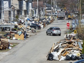 After a dike broke debris lines a street as clean up continues in parts of Ste.Marthe-sur-la-Lac, Que., Monday, May 6, 2019.&ampnbsp;