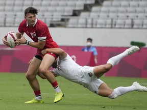 Canada's Andrew Coe is tackled by Madison Hughes of the United States, in their men's rugby sevens 5-8 placing match at the 2020 Summer Olympics, Wednesday, July 28, 2021 in Tokyo, Japan.&ampnbsp;The New York Ironworkers, who won the Major league Rugby championship in 2022. have joined the Toronto Arrows in closing shop. The league confirmed the franchise was folding.