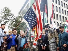 Iranians burn a U.S. flag