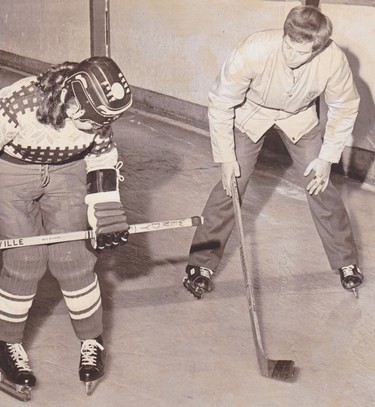 Coach Bernie Alain helps Eileen Yewchuk learn how to skate backwards at Edmonton's Jasper Place Arena October 1972.