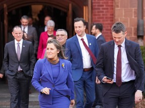 Chrystia Freeland walks with a group of provincial and territorial finance ministers.