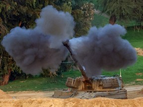 An Israeli army self-propelled artillery howitzer fires rounds.
