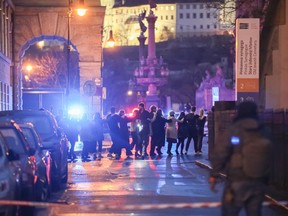 University students are evacuated by police at the location of a mass shooting in Prague.