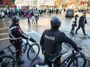 Police keep watch over pro Palestinian protesters marching in Calgary, Atla., on Dec. 10, 2023.
