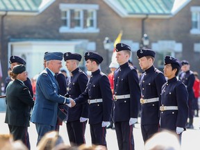 Brigadier-General Pascal Godbout shakes hands with first-year Royal Military College officer cadets.