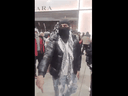 An unnamed protester at the Toronto Eaton Centre Sunday gestures while facing Toronto police officers.