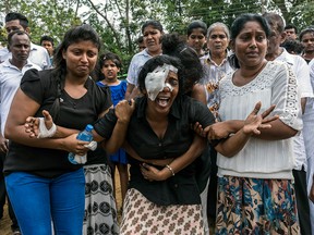 Mourners grieve at a mass burial near St. Sebastian's Church in Negombo, Sri Lanka, on April 24, 2019.