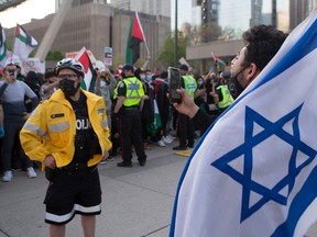 A pro-Israel supporter chants at pro-Palestine supporters during a demonstration against the current violence in Gaza in Toronto on Saturday, May 15, 2021.