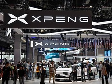 People visit a booth for the Chinese EV giant XPeng at the Shanghai International Automobile Industry Exhibition on April 19, 2023.
