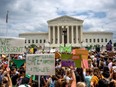 A crowd protests in front of the U.S. Supreme Court.