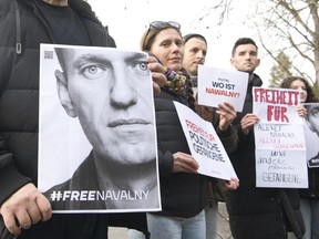 Demonstrators gather outside the home of Russian ambassador Sergei Netshaev in Berlin, Saturday Dec. 16, 2023.