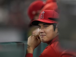Los Angeles Angels' Shohei Ohtani sits in the dugout during the tenth inning of a baseball game against the Detroit Tigers in Anaheim, Calif., Saturday, Sept. 16, 2023.