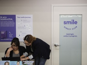 FILE - Dental assistants go over appointments at SmileDirectClub's SmileShop located inside a CVS store April 24, 2019, in Downey, Calif. SmileDirectClub is shutting down, just months after the struggling teeth-straightening company filed for bankruptcy, leaving existing customers in limbo. On Friday, Dec. 8, 2023, the company said it was unable to find a partner willing to bring in enough capital to keep the company afloat, despite a months-long search.
