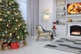 Beautiful tree with festive lights and Christmas decor in living room. Interior design