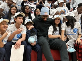 Toronto Raptors' Pascal Siakam sits with students at Monsignor Percy Johnson Catholic Secondary School, in Toronto on Tuesday, December 19, 2023. Siakam's PS43 charity has supported Data Dunkers, an extracurricular program where students in the Toronto Catholic District School Board learn about data science using statistics from the NBA and WNBA, for more than a year.