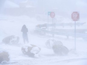 A pedestrian leaves the Iqaluit Airport as a winter storm hits Iqaluit, Nvt., on Thursday, March 7, 2019.