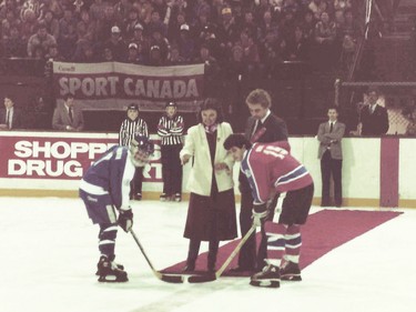 Chimos captain Shirley Cameron and Quebec player Danielle Goyette take the ceremonial puck drop from Maureen McTeer at the 1984 nationals in Summerside, P.E.I.