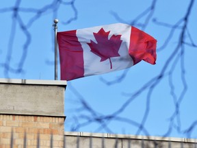 A Canadian flag flies over a Canadian embassy.